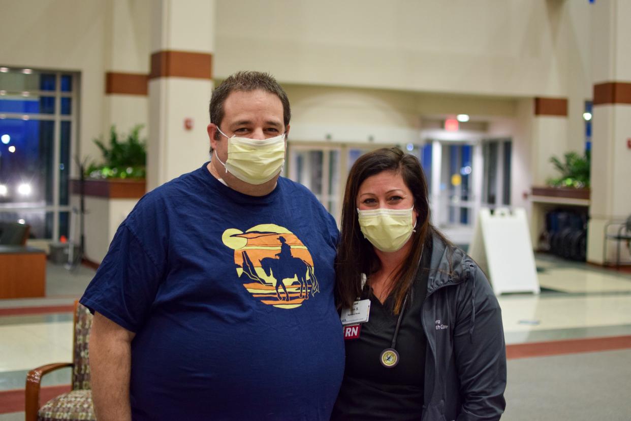 Ryan Suetta (left) poses for a photo with Grafton nurse Jen Stern after being discharged from the hospital. Stern was at a Port Washington bar on New Year's Eve when she helped save Suetta's life after he collapsed.