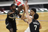 Houston Rockets' Kenyon Martin Jr. drives to the basket between Milwaukee Bucks' Bryn Forbes (7) and Bobby Portis (9) during the first half of an NBA basketball game Friday, May 7, 2021, in Milwaukee. (AP Photo/Aaron Gash)