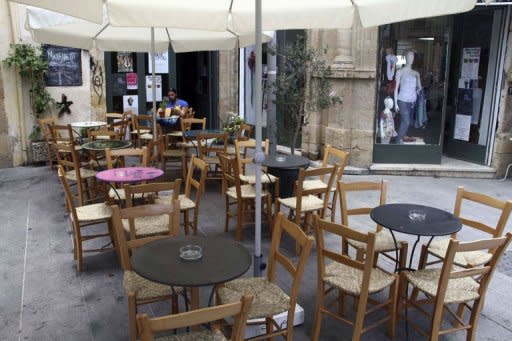 A man sits at an empty coffee shop in Old Nicosia in the Cypriot capital on June 22, 2012. Cyprus has requested assitance from its eurozone parters, becoming the fifth out the 17 countries to share the euro to seek a rescue