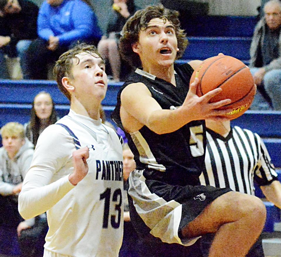 Waverly-South Shore's Cooper Schmit (5) drives to the basket against Great Plains Lutheran's Alex Heil during their Eastern Coteau Conference boys basketball game Tuesday night in Watertown. Great Plains Lutheran won 58-51.