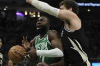 Boston Celtics' Jaylen Brown loses the ball in front of Milwaukee Bucks' Brook Lopez during the first half of an NBA basketball game Tuesday, April 9, 2024, in Milwaukee. (AP Photo/Morry Gash)