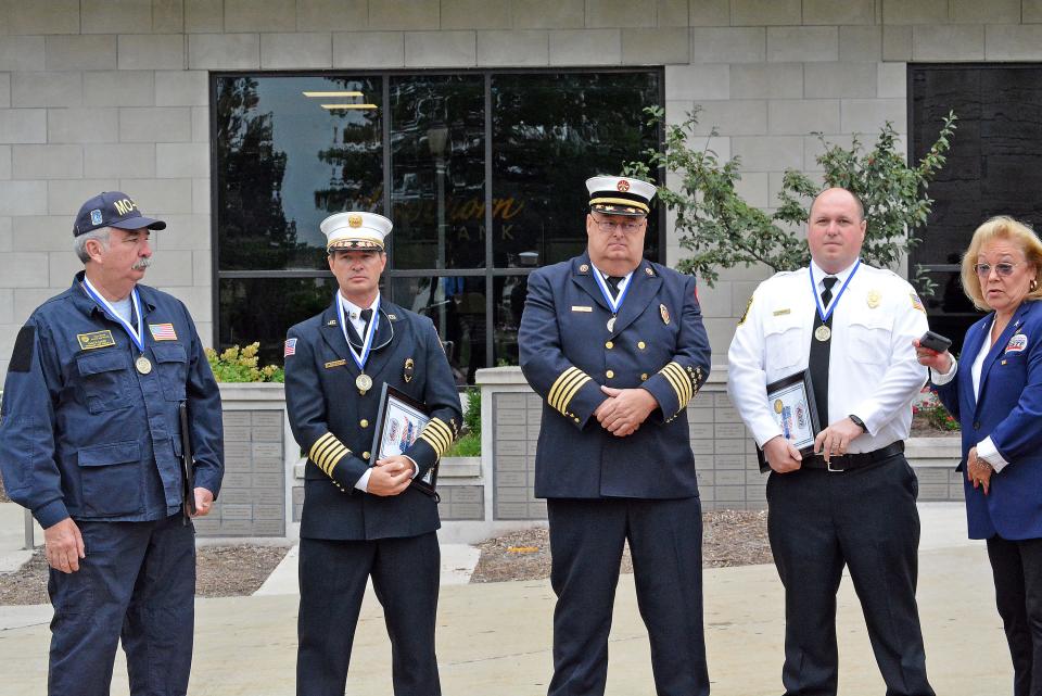 Boone County Fire Assistant Chief Chuck Leake, from left, Jefferson City Fire Chief Matt Schofield, Columbia Assistant Fire Chief Jerry Jenkins and Southern Boone County Deputy Chief Colin Wright all were part of or aided Missouri Task Force 1 when it was deployed to New York on Sept. 11, 2001. They were recognized Monday for their work by U.S. Exercise Tiger Foundation Executive Director Susan Haines, right.