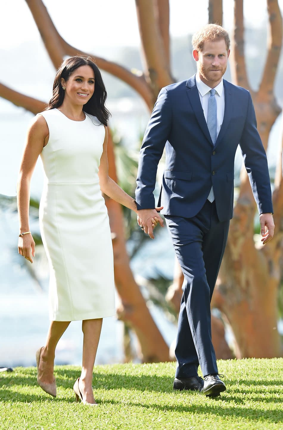 <p>On their royal tour of Australia, Meghan wore a simple white sheath dress to the Admiralty House in Sydney, Australia.</p>