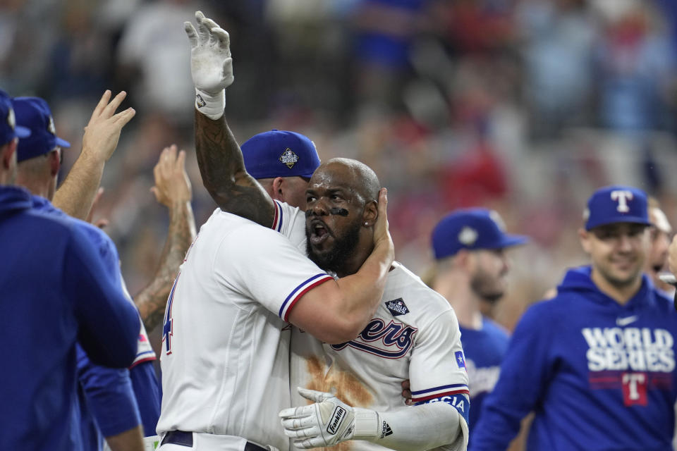 Texas Rangers' Adolis Garcia celebrates with teammates after hitting a game-winning home run against the Arizona Diamondbacks during the 11th inning in Game 1 of the baseball World Series Friday, Oct. 27, 2023, in Arlington, Texas. The Rangers won 6-5. (AP Photo/Godofredo A. Vásquez)