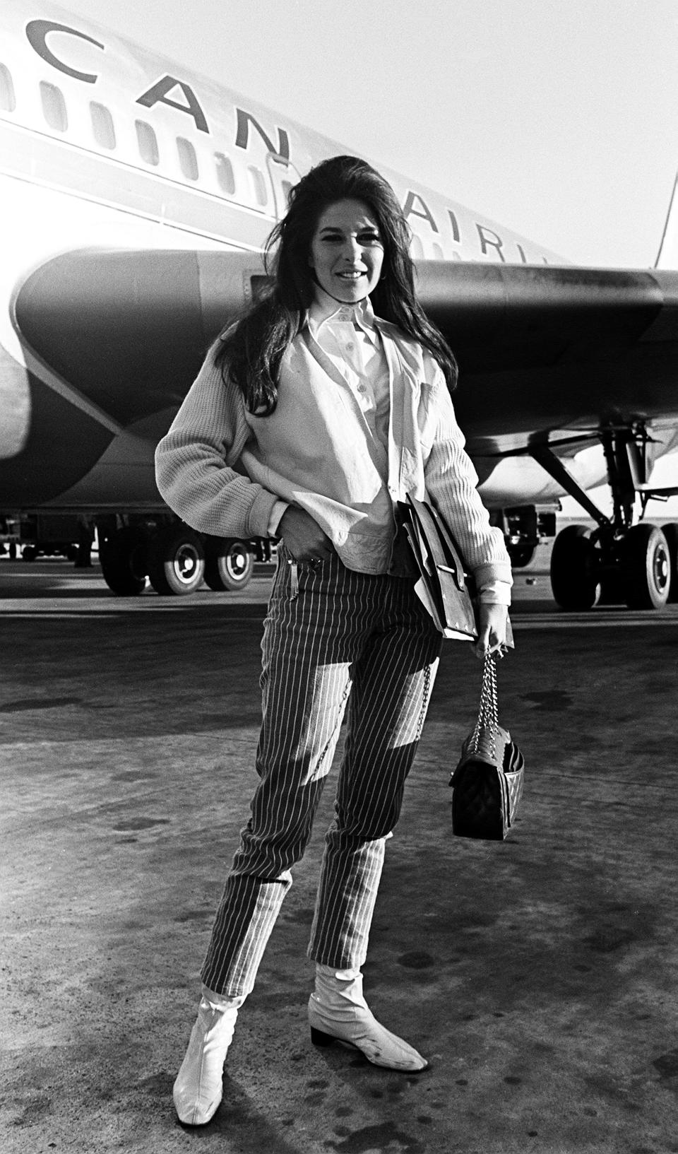 Singer Bobbie Gentry poses for photographers outside the airport in Nashville in 1967.