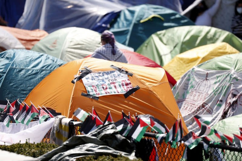 Signs hang on the tents inside the Pro-Palestinian encampment on the grounds of Columbia University in New York on Friday. The University announced that classes would be held remotely starting Monday, as pro-Palestinian protests have continued for almost tow weeks on the school's campus. Photo by John Angelillo/UPI