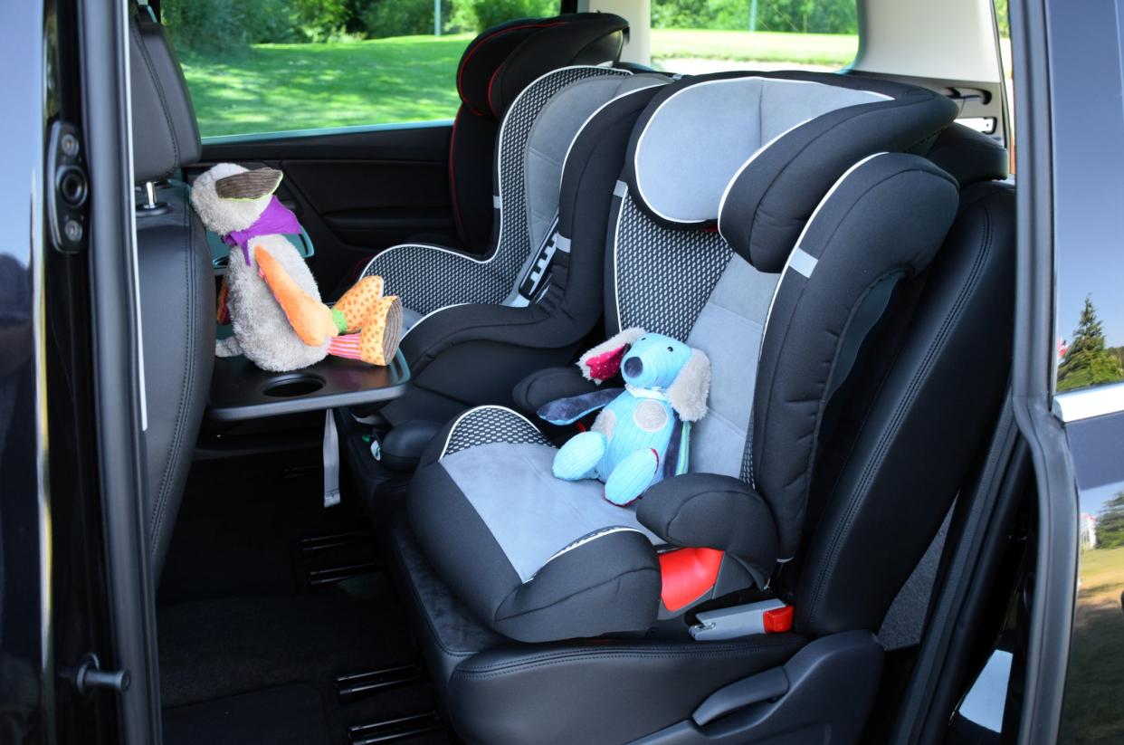 Side shot on the seats for children mounted in minivan.