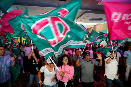 Supporters of presidential candidate Romulo Roux of the Democratic Change (CD) wave flags as they wait for the election results in Panama City, Panama May 5, 2019. REUTERS/Jose Cabezas
