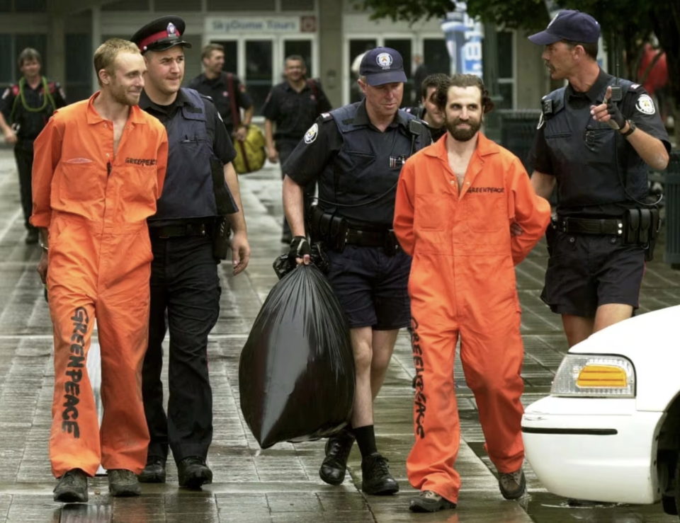 Guilbeault, second from right, scaled the CN Tower in Toronto in 2001 to protest Canada's environmental policies. He was arrested for the stunt. (Aaron Harris/The Canadian Press)