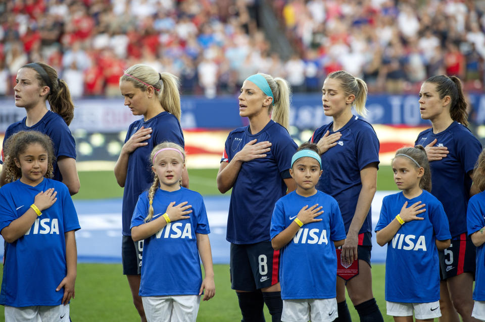 United States players Tierna Davidson, Lindsey Horan, Julie Ertz, Abby Dahlkemper, and Kelley O'Hara stand with their jerseys turned inside out during the playing of the national anthem before a SheBelieves Cup women's soccer match against Japan, Wednesday, March 11, 2020 at Toyota Stadium in Frisco, Texas. (AP Photo/Jeffrey McWhorter)