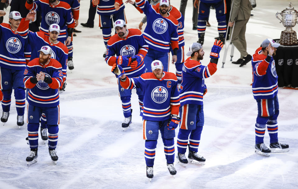 Edmonton Oilers players wave to fans after defeating the Dallas Stars in Game 6 of the Western Conference finals of the NHL hockey Stanley Cup playoffs in Edmonton, Alberta, Sunday, June 2, 2024. (Jeff McIntosh/The Canadian Press via AP)