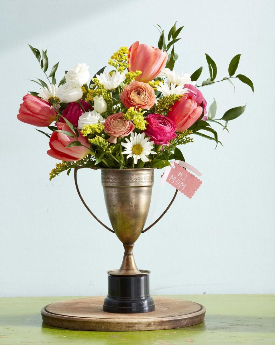 <p>Your mom's a real winner — and this beautiful bouquet will serve as the perfect reminder. Track down a vintage prize trophy (or <a href="https://www.amazon.com/Decade-Awards-Gold-Silver-Corporate-Trophies/dp/B011LX2P7K/?tag=syn-yahoo-20&ascsubtag=%5Bartid%7C10055.g.2412%5Bsrc%7Cyahoo-us" rel="nofollow noopener" target="_blank" data-ylk="slk:pick up a plastic one on Amazon;elm:context_link;itc:0;sec:content-canvas" class="link ">pick up a plastic one on Amazon</a>) and then fill it with garden-fresh blooms. </p><p><em><a href="https://www.countryliving.com/diy-crafts/how-to/g771/mothers-day-crafts-0509/" rel="nofollow noopener" target="_blank" data-ylk="slk:Get the tutorial at Country Living »;elm:context_link;itc:0;sec:content-canvas" class="link ">Get the tutorial at Country Living » </a></em></p>