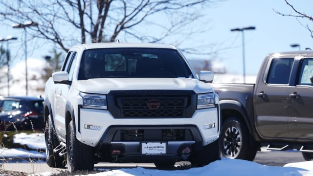 Unsold 2024 Frontier pickup trucks sit outside a Nissan dealership.
