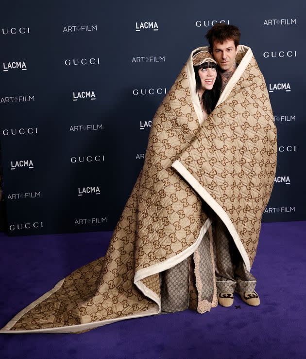 Eilish and Rutherford wore Gucci pyjamas, wrapped in a large blanket monogrammed with the fashion house's logo.  (Photo: MICHAEL TRAN via Getty Images)