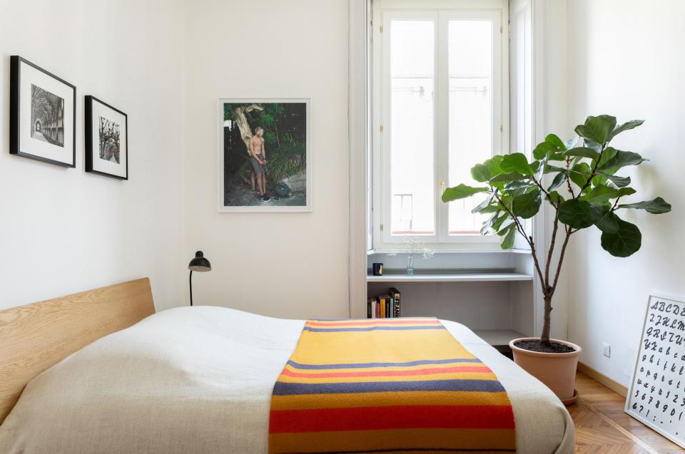 The guest bedroom mirrors Alex’s, with the same Muji bed topped by an Hermès blanket—this time in a striking orange colorway. A chromogenic print by Thomas Humery hangs on the wall beside the window and a poster by Rayyane Tabet is casually propped on the floor.