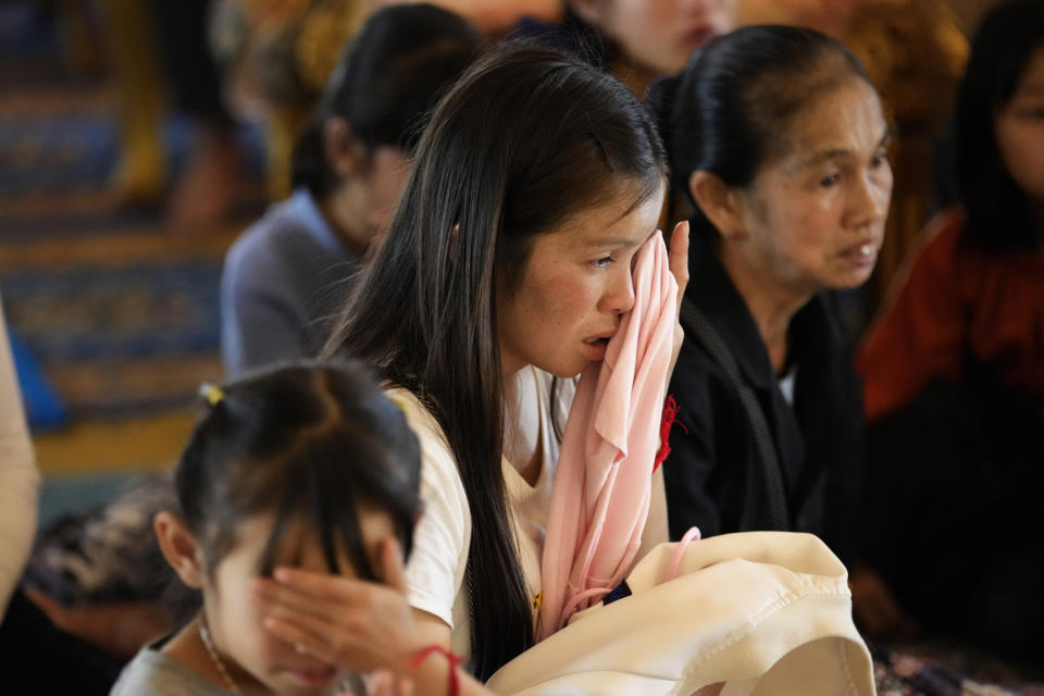 Family members cry during a funeral for Duangphet Phromthep, one of the 12 boys rescued from a flooded cave in 2018, at Wat Phra That Doi Wao temple in Chiang Rai province, Thailand, Sunday, March 5, 2023. The cremated ashes of Duangphet arrived in the far northern Thai province of Chiang Rai on Saturday where final Buddhist rites for his funeral will be held over the next few days following his death in the U.K. (AP Photo/Sakchai Lalit)