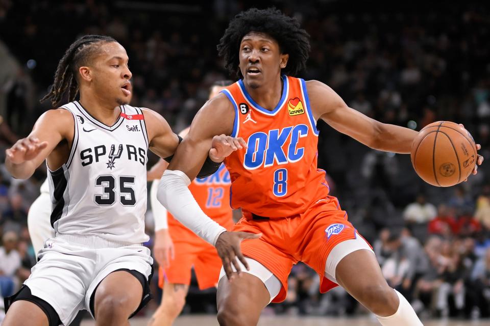 Oklahoma City Thunder's Jalen Williams (8) drives against San Antonio Spurs' Romeo Langford during the first half of an NBA basketball game, Sunday, March 12, 2023, in San Antonio. (AP Photo/Darren Abate)