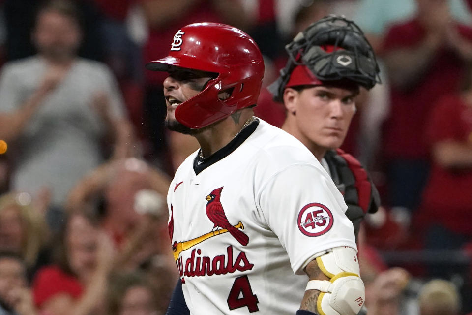 St. Louis Cardinals' Yadier Molina, left, celebrates after hitting a two-run home run as Cincinnati Reds catcher Tyler Stephenson watches during the fourth inning of a baseball game Friday, Sept. 10, 2021, in St. Louis. (AP Photo/Jeff Roberson)