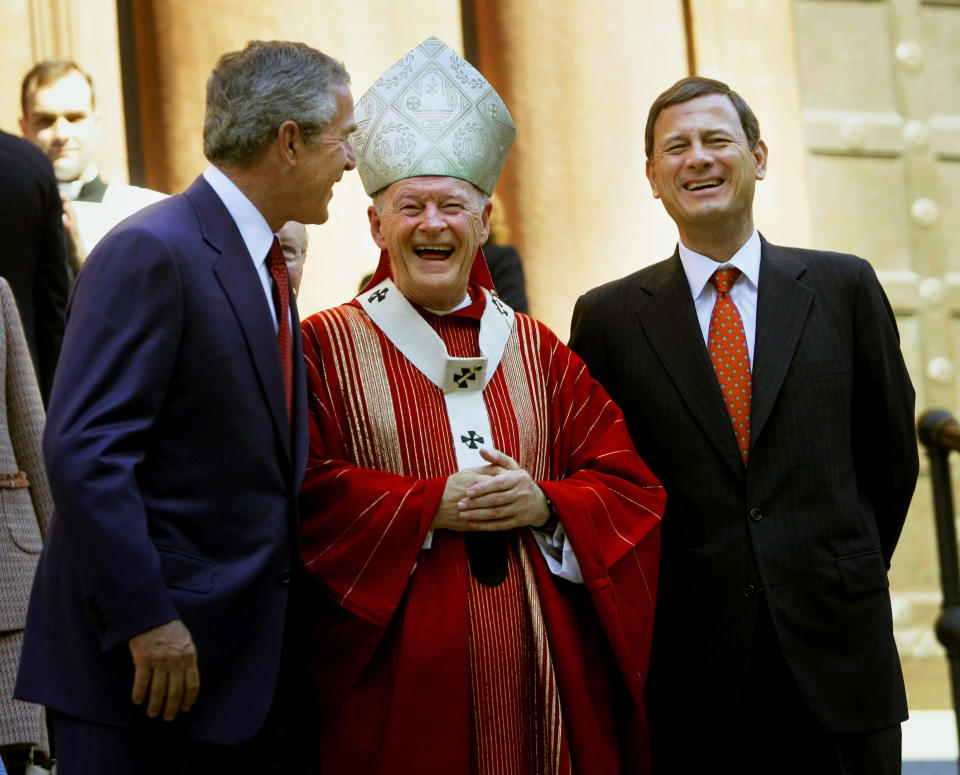 FILE - In this Oct. 2, 2005 file photo, President Bush, left, laughs with Cardinal Theodore E. McCarrick Archbishop of Washington, D.C., center, and Chief Justice of the United States John Roberts, right, as they walk out of St. Matthew's Cathedral after attending the 52th Annual Red Mass in Washington. The Red Mass is held on the Sunday prior to the opening of the Supreme Court's session. (AP Photo/Pablo Martinez Monsivais, File)