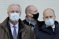 EU Chief Negotiator Michel Barnier, left, waits to cross the street as he walks to attend Brexit trade negotiations at a conference centre, in London, Tuesday, Dec. 1, 2020. Teams from Britain and the European Union are continuing face-to-face talks on a post-Brexit trade deal with little time remaining. (AP Photo/Matt Dunham)