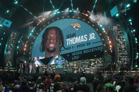 LSU wide receiver Brian Thomas Jr. stands on stage after being chosen by the Jacksonville Jaguars with the 23rd overall pick during the first round of the NFL football draft, Thursday, April 25, 2024, in Detroit. (AP Photo/Paul Sancya)