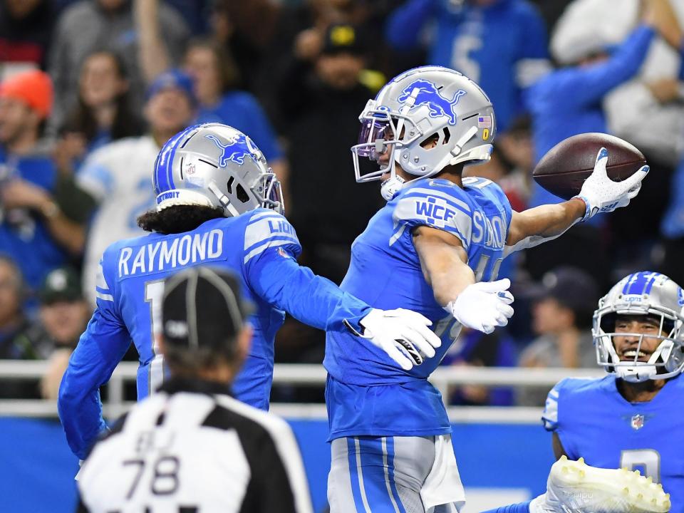 Amon-Ra St. Brown celebrates a touchdown against the Arizona Cardinals.