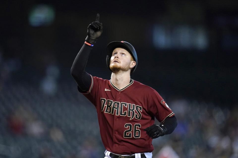 Arizona Diamondbacks' Pavin Smith points to the sky as he arrives at home plate after hitting a home run against the Pittsburgh Pirates during the seventh inning of a baseball game Wednesday, July 21, 2021, in Phoenix. The Diamondbacks defeated the Pirates 6-4. (AP Photo/Ross D. Franklin)