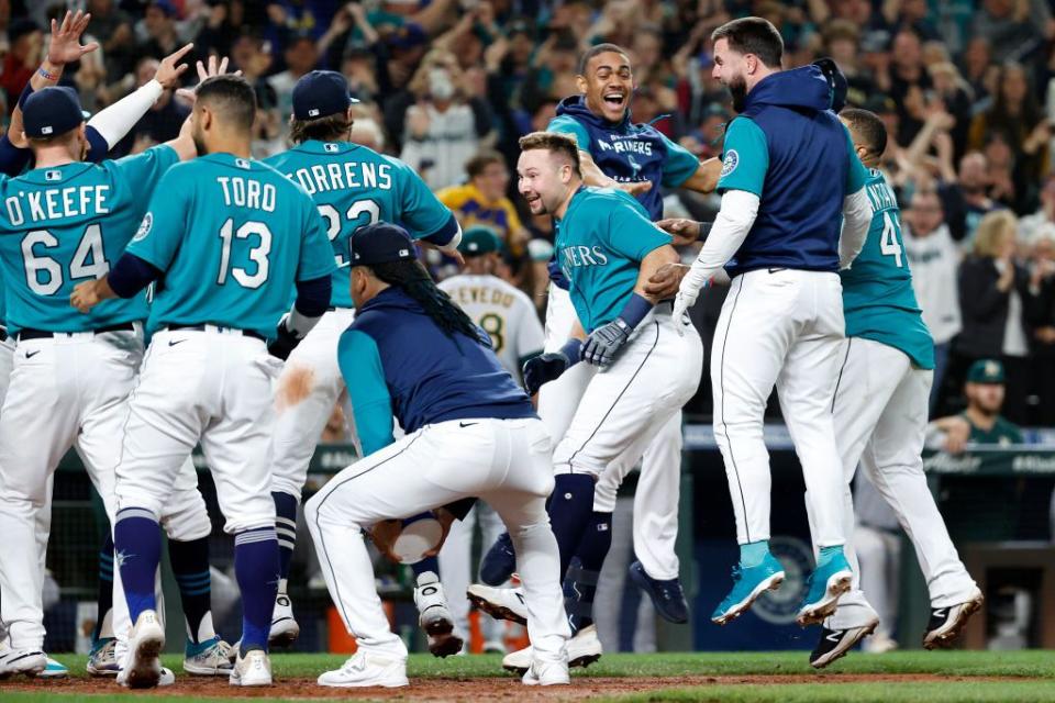 SEATTLE, WASHINGTON - SEPTEMBER 30: Cal Raleigh #29 of the Seattle Mariners celebrates his walk-off home run during the ninth inning against the Oakland Athletics at T-Mobile Park on September 30, 2022 in Seattle, Washington. With the win, the Seattle Mariners have clinched a postseason appearance for the first time  in 21 years, the longest playoff drought in North American professional sports. (Photo by Steph Chambers/Getty Images)