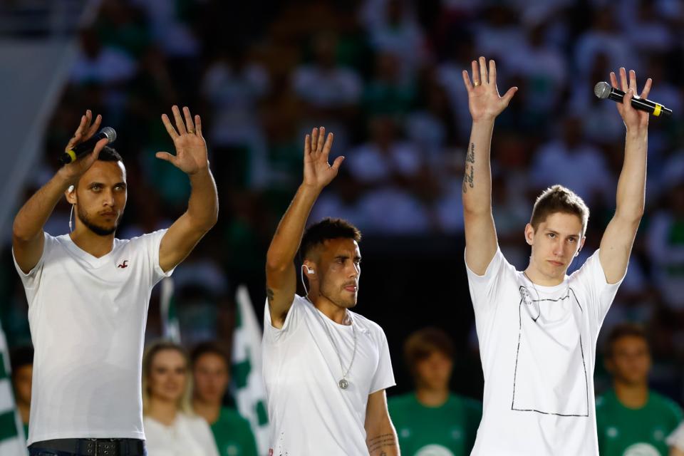 <p>Plane crash survivors Helio Hermito Zampier Neto, Alan Ruschel and Jakson Follmann greet the crowd </p>