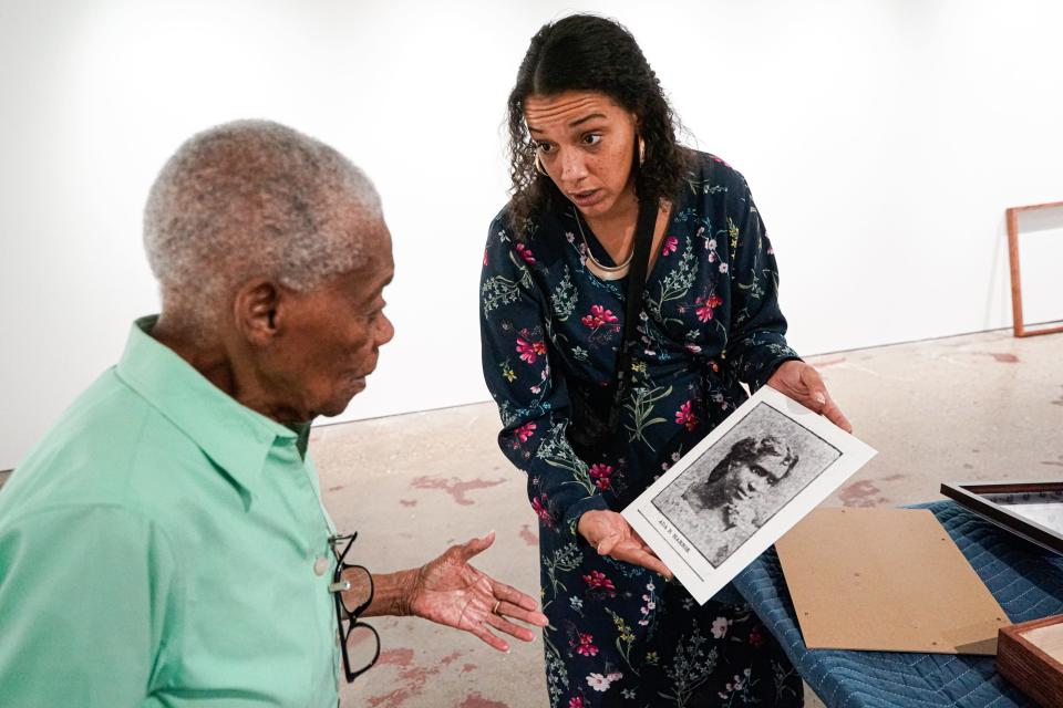 From left, Flinora Frazier, the grand daughter of Penick Chapel AME Zion Church founder, Rev. Sidney Penick visits Historian and Artist Kaila Austin and her solo art show titled "Process as Practice: Reimagining the Lost Hardrick Mural" on Wednesday, Oct. 4, 2023, at the Tube Factory artspace in Indianapolis. The show features Austin's work with Frazier and other residents of the historic Norwood neighborhood, a Freetown founded by Black Civil War veterans and those who moved here from the south. Here Austin holds a photograph of School Master Ada B. Harris, who ran the Norwood Colored School from 1898-1914 when the school was annex into the city and she was removed from her position.