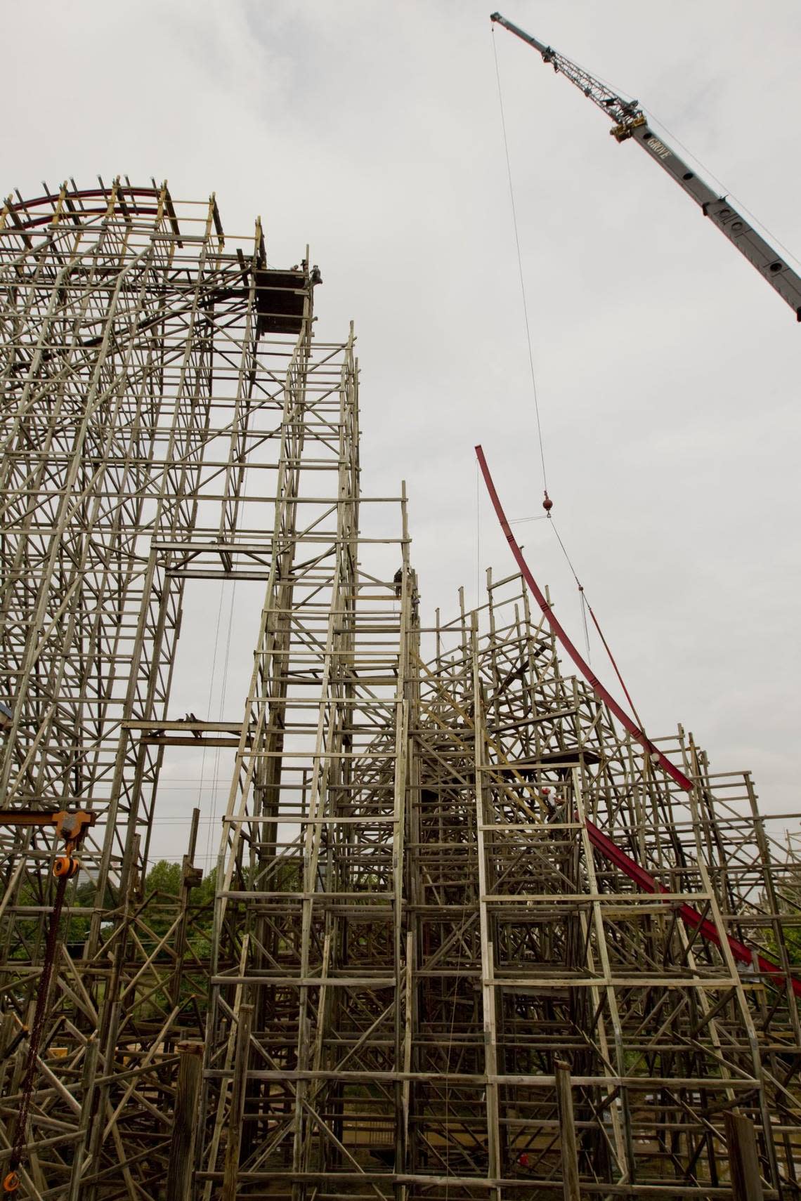 July 1, 2010: Crews use a crane to lower a piece of steel track onto the wood frame of the Texas Giant at Six Flags Over Texas in Arlington. The Texas Giant will feature the steepest drop in the world at 79 degrees when it reopens in spring 2011.