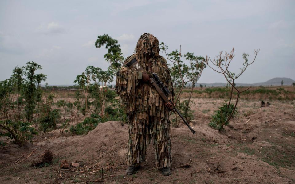 A member of the Nigerian Armed Forces Sniper Unit wearing a ghillie suit poses for a photo during the African Land Forces Summit (ALFS)  - AFP