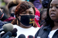 Tamika Palmer, the mother of Breonna Taylor, left, listens to a news conference, Friday, Sept. 25, 2020, in Louisville, Ky. Family attorney Ben Crump is calling for the Kentucky attorney general to release the transcripts from the grand jury that decided not to charge any of the officers involved in the Black woman's death. (AP Photo/Darron Cummings)