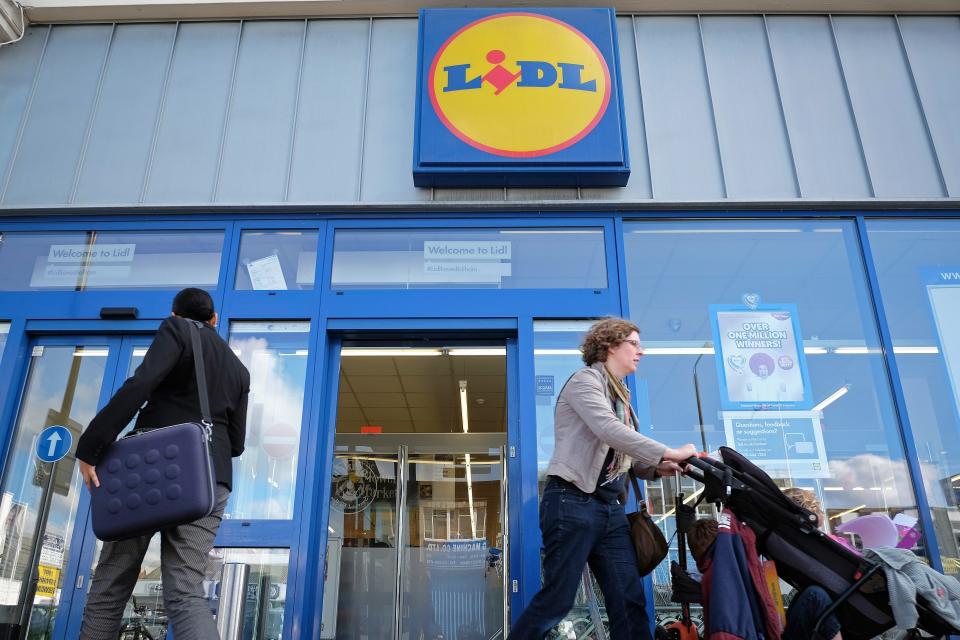 Shopper exits a Lidl grocery store.