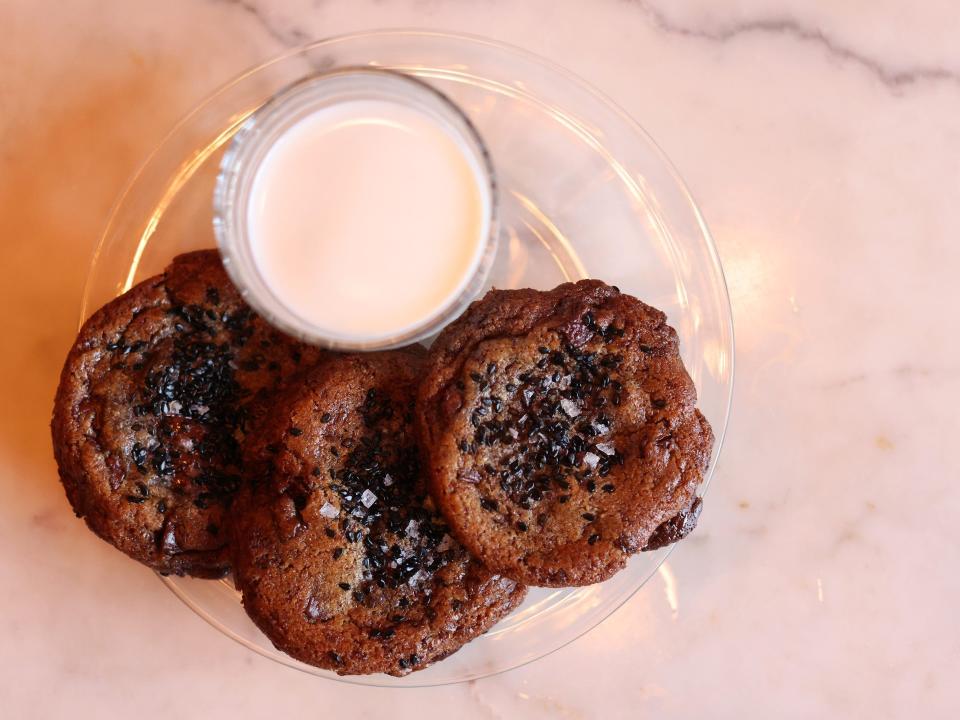 A birds eye view of cookies and milk.