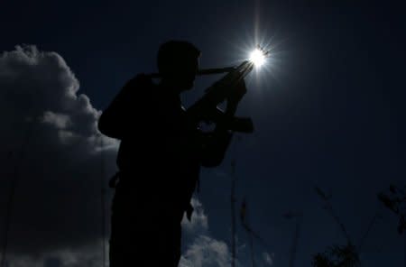 FILE PHOTO: A Free Syrian army fighter holds his weapon in Jubata al-Khashab in Quneitra province, Syria, November 4, 2017. REUTERS/Alaa Al-Faqir/File Photo