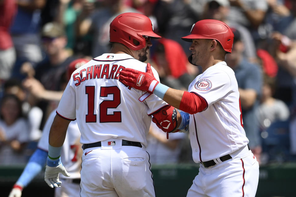 Washington Nationals' Kyle Schwarber (12) celebrates his two-run home run with Gerardo Parra, right, during the seventh inning of a baseball game against the New York Mets, Sunday, June 20, 2021, in Washington. (AP Photo/Nick Wass)