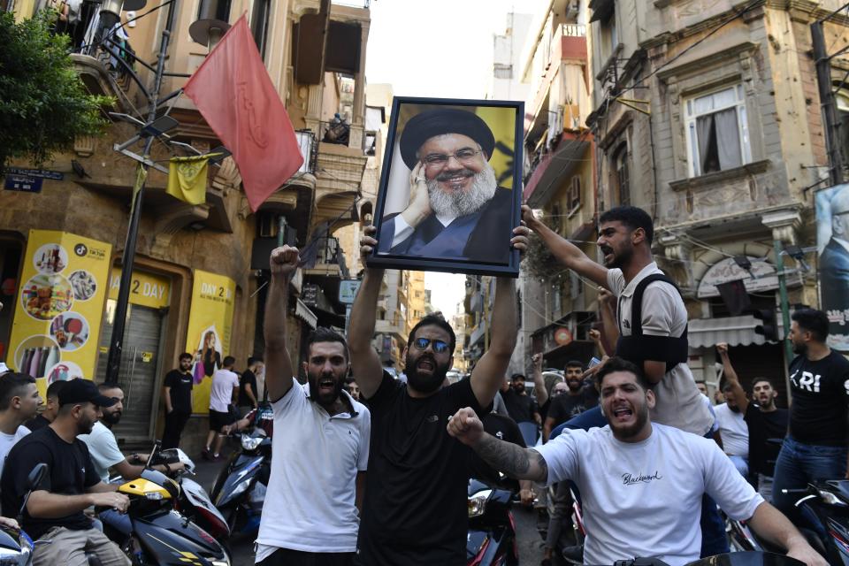 A group gather carrying Nasrallah's poster in Beirut, Lebanon (Anadolu via Getty Images)