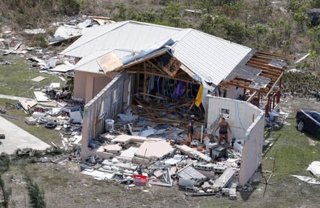 Residents look through debris after hurricane Dorian hit the Grand Bahama Island in the Bahamas