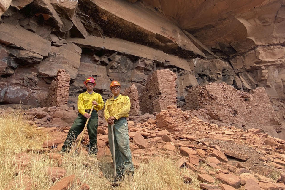 This 2021 photo provided by the U.S. Forest Service, shows Michael Terlep, left, and Jason Nez at the Honanki Ruins Heritage Site near Sedona, Arizona. The archaeologists were assessing the risk of wildfire and potential impacts if it reached the site. (U.S. Forest Service via AP)