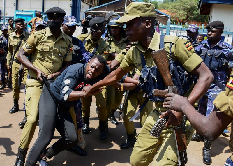 Ugandan riot police officers detain an activist during a march in support of the European Parliament resolution to stop the construction of the East African Crude Oil Pipeline in Kampala