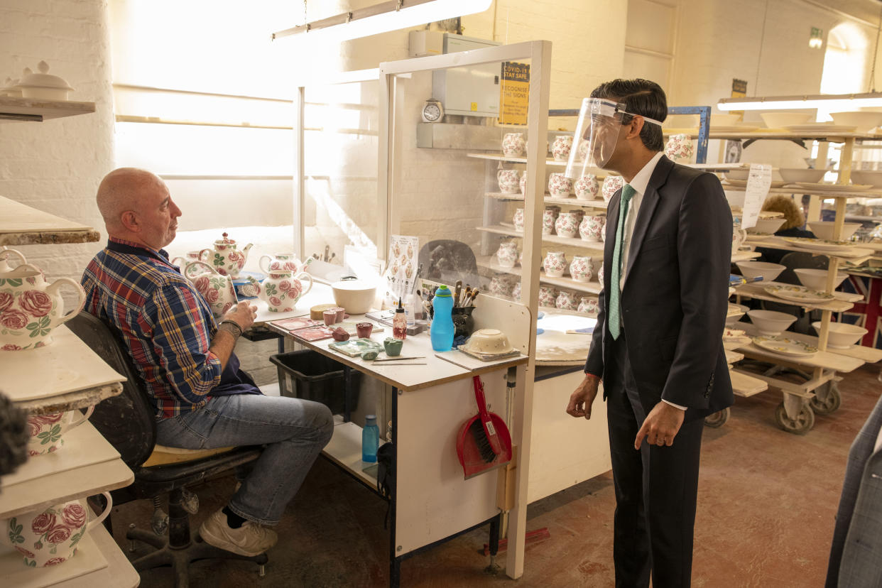 STOKE-ON-TRENT, ENGLAND - SEPTEMBER 14: Chancellor Rishi Sunak chats to Colin Colcloughl during a visit to the Emma Bridgewater pottery after employees returned back to work after being furloughed on September 14, 2020 in Stoke-on-Trent, England. (Photo by Andrew Fox - WPA Pool / Getty Images)