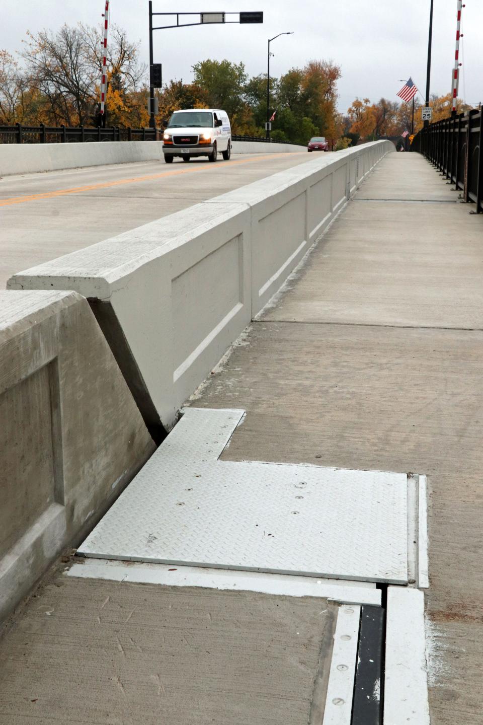 A gap exists alongside a metal plate on the sidewalk of the Racine Street bridge in Menasha.