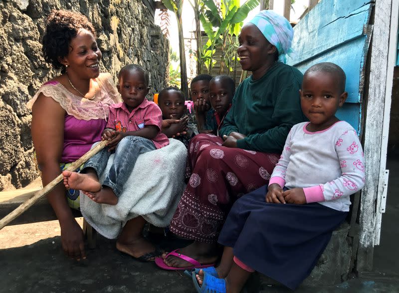 Esperance Nyabintu and her son Ebenezer Fataki, the only two Ebola survivors of Goma; talk to their neighbours at their compound within Bugamba locality in Goma