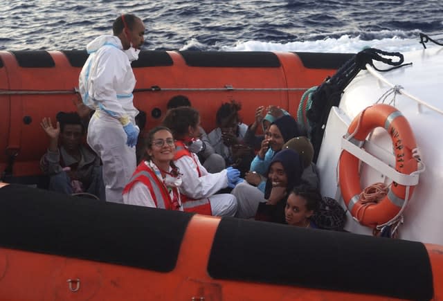 Migrants are evacuated by Italian coastguards