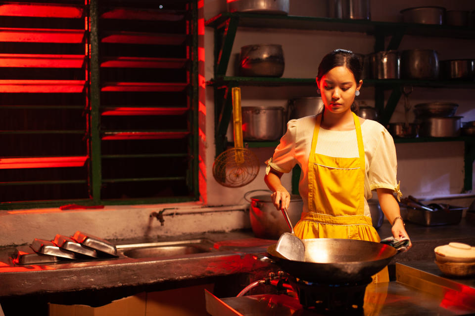 Fang Rong cooking in a still from 'Fried Rice Paradise'. (PHOTO: Mediacorp)