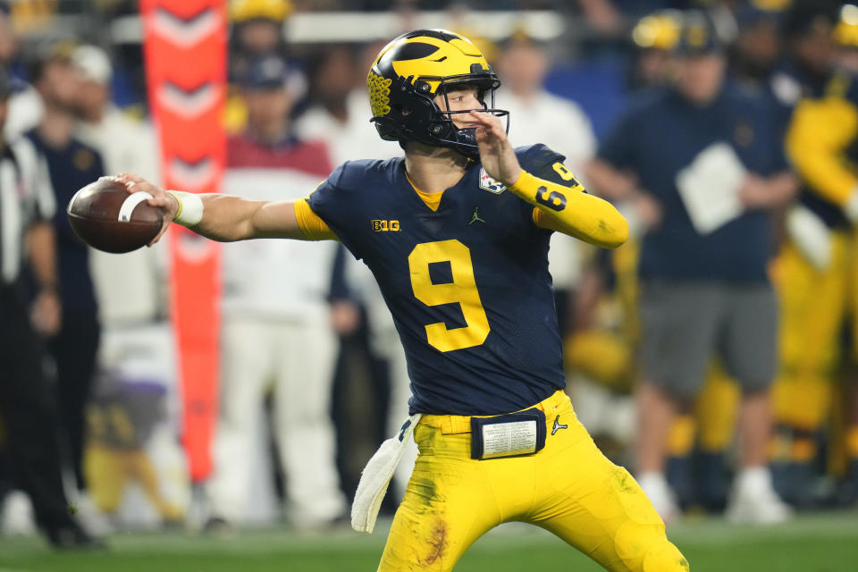 Michigan quarterback J.J. McCarthy (9) throws abasing TCU during the second half of the Fiesta Bowl NCAA college football semifinal playoff game, Saturday, Dec. 31, 2022, in Glendale, Ariz. (AP Photo/Ross D. Franklin)