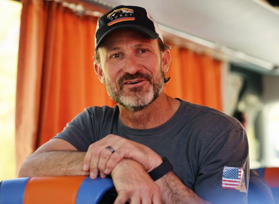 Bruce Roberts, founder and CEO of August Mission, stands on a bus talking with delegation members as they travel into Ukraine from Poland on Monday, May 1, 2023. | Scott G Winterton, Deseret News