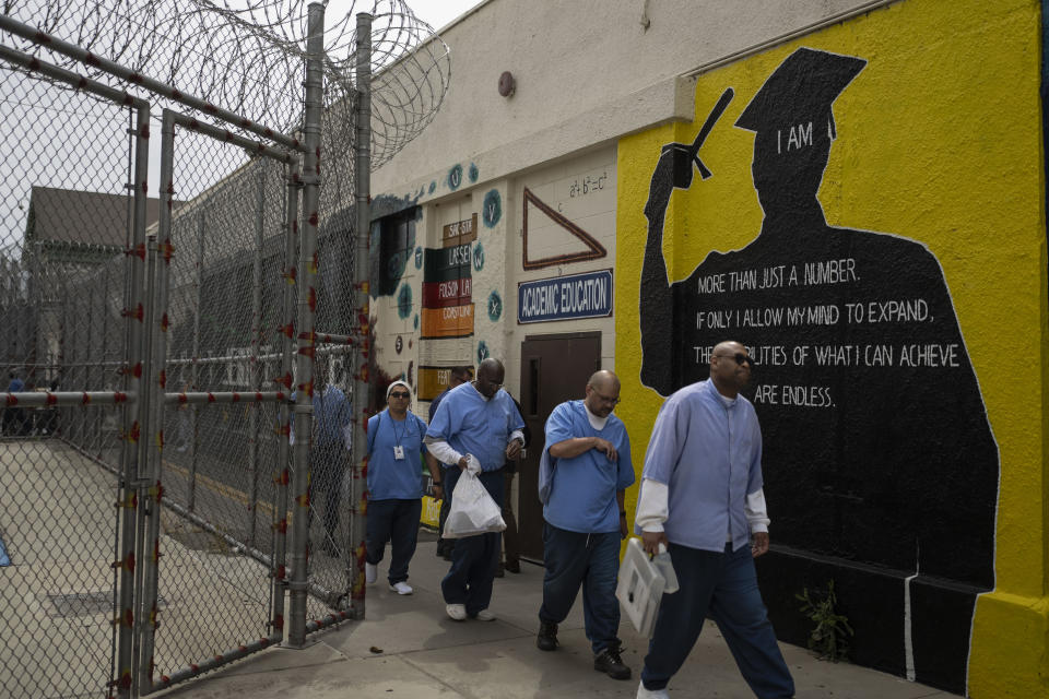 Prisoner-students majoring communications, Jamal Lewis, from right, Lambert Pabriaga and Sherman Dorsey walk to their class at Folsom State Prison in Folsom, Calif., Wednesday, May 3, 2023. Under the Free Application for Federal Student Aid (FAFSA) Simplification Act, more than 760,000 people in prison will become eligible for Pell Grants once the law is implemented on July 1. Prison education advocates say it's not a matter of if, but when recidivism rates drop and job attainment begins to rise. (AP Photo/Jae C. Hong)