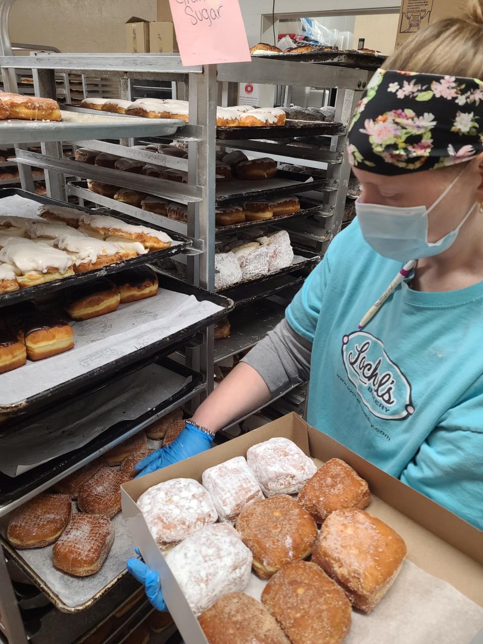 Lochel's store supervisor Cailin Driscoll prepares fasnachts for the Tuesday before Ash Wednesday.